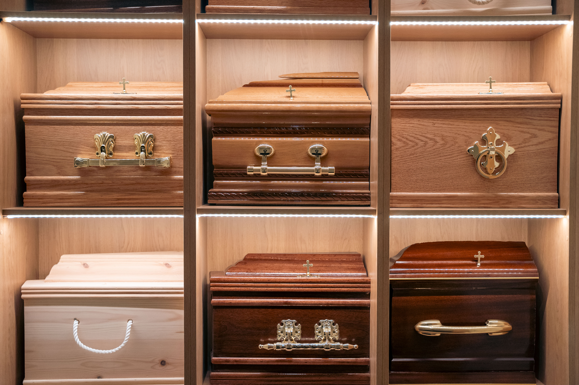 A display showing a range of coffin styles and finishes